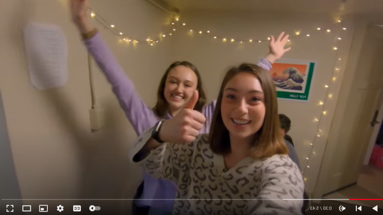 two students celebrating in their dorm room